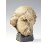 A carved marble male head possibly Christ, modelled with detailed hair and beard, 11.5cm high, set
