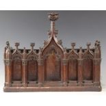 A late 15th century and later carved pine niche, designed with nine tracery surrounds, with