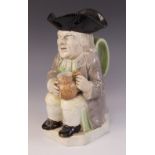 A Staffordshire pearlware Toby Jug, circa 1790, of traditional form modelled holding a jug in both