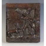 An early 16th century walnut naïve carved square panel, depicting a male blowing a horn with a deer,