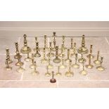 A large collection of 18th century and later brass candlesticks, to include; continental and