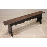 A 17th century and later constructed oak bench or form, the rectangular top with a moulded edge over