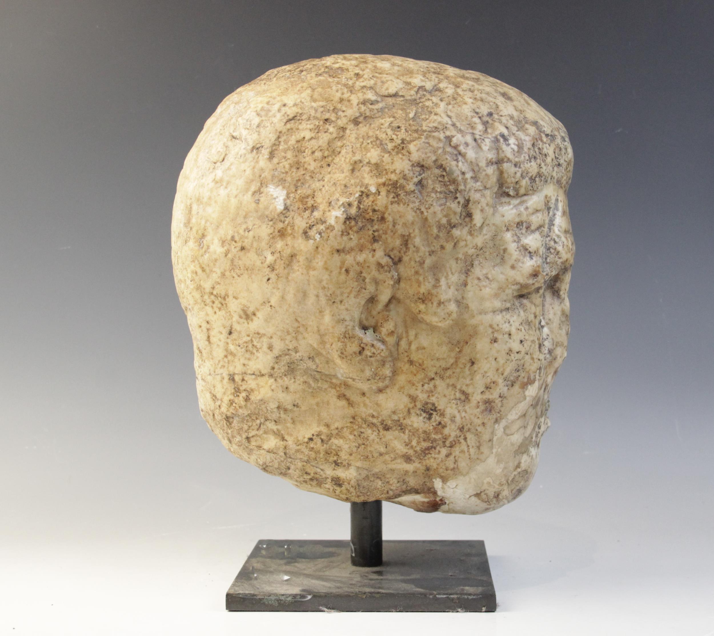 A worn marble male head carved with deeply furrowed brow, with restorations, 26cm high Provenance: - Image 6 of 8