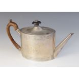 A George III silver teapot, Henry Chawner, London 1792, of oval form with hinged cover, wooden