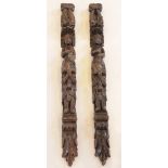 A pair of carved oak pilasters, Flemish, each designed with a figure topped with paired dolphins,