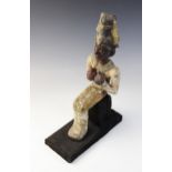 An Egyptian style gesso painted seated wood figure of a pharaoh, wearing the atef crown, Not