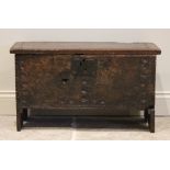 A mid 17th century and later Welsh oak six plank coffer bach, the hinged top with a serrated edge