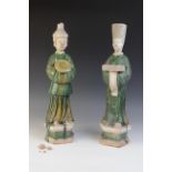 A pair of large Chinese Sancai glazed attendants, possibly Ming dynasty, male and female, one