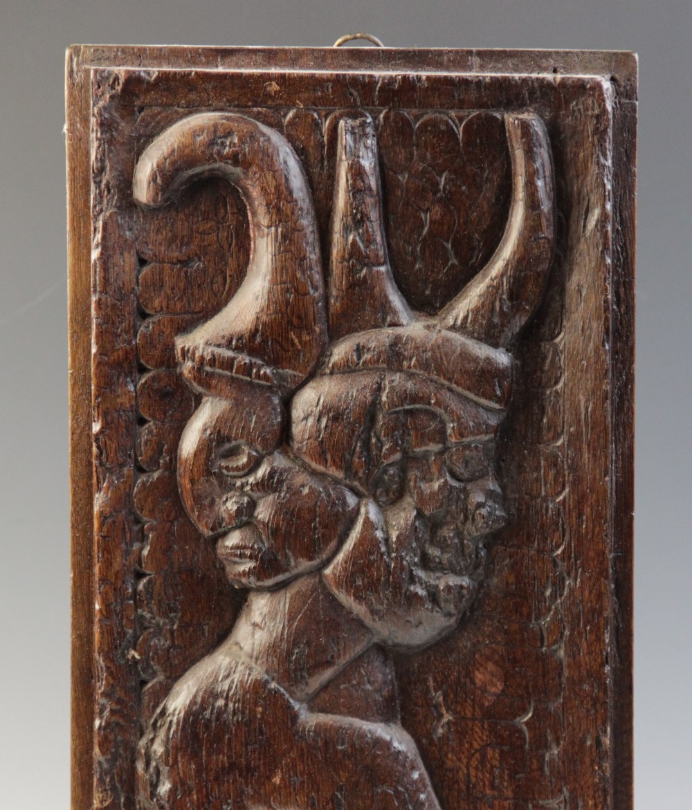 A 16th century carved oak panel, carved with a grotesque beast against a naïve scalloped and foliate - Image 2 of 4