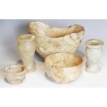 A selection of carved alabaster vessels, to include a navette shaped vessel, 20.5cm wide, two