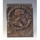 A mid 16th century oak Romayne type carved oak panel, design with a bearded male within circular