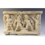A marble rectangular relief deeply carved with four figures, two shield-bearing soldiers, one