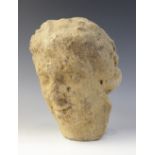 A carved stone head in the classical manner, possibly Venus, with flowing hair, 26cm high