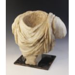 A Roman marble bust with the folds of the tunic deeply carved, set on an integral tapered socle,