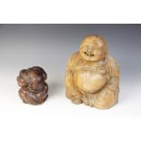 An Eastern carved figure of a Buddha, modelled seated laughing, 25cm high with a Orang Malu carving,