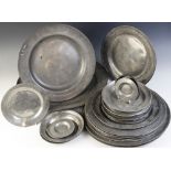 A large selection of pewter chargers, of assorted dates and styles, measuring between 11.6cm and