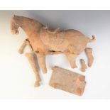 A large Chinese pottery model of a horse, possibly Tang dynasty, modelled on four legs, and