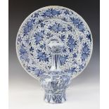 A Dutch delft charger, 18th century, busily decorated in blue throughout with stylised flowers and