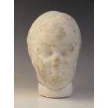 A marble head of a child with heavily worn features, with restorations, 22cm high Provenance: Ex Ali