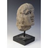 A carved stone male head, 26.5cm high, mounted upon a rod and square plinth base, overall 37.5cm