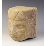 A carved stone corbel, in the medieval style, depicting a gentleman with distinctive hair and hat,