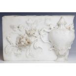 A marble carving fragment, depicting a classical urn within a floral surround, 27.5cm W x 18cm L x