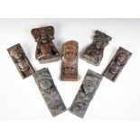 A group of seven oak figural corbels, including a pair of male masks with plumed headdress 20cm