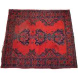 A Turkish wool rug, in red, blue and green colourways, the three central medallions upon a vibrant