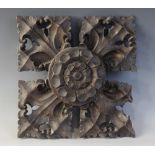 A late 15th century oak ceiling/roof boss, of square leafy quatrefoil form, centred by a Tudor rose,