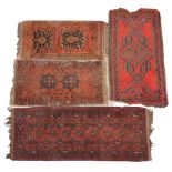 Four assorted small Persian pattern hand knotted wool rugs, each with multiple gulls upon a red