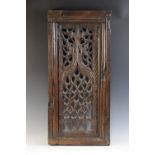 An early 16th century carved oak and pierced tracery panel, circa 1500, the rectangular panel