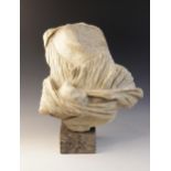 A fragmentary marble bust, the right hand emerging from the folds of the deeply carved drapery,