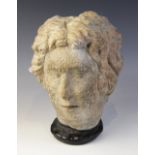 A carved stone female head, in the classical manner, upon later base, 29cm high