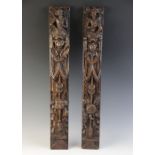 A pair of carved oak terms, Flemish, circa 1600, designed with a male and female figure atop a