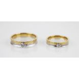 A pair of diamond set 18ct gold wedding bands, each designed as a white and yellow gold band, the