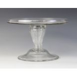 A glass tazza, late 18th century, the flat galleried top raised on a reeded lobed hollow stem of