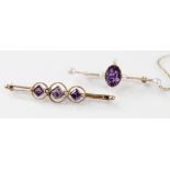 A Victorian amethyst and pearl brooch, the central oval amethyst measuring 9mm x 7mm, flanked by