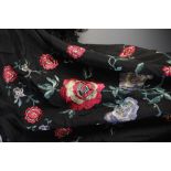 A Victorian piano shawl, 19th century, with polychrome silk embroidered floral motifs against a