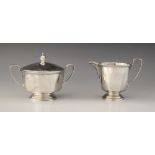 A George V silver milk jug and sucrier, Adie Brothers Ltd, Birmingham 1935, each of tapering faceted