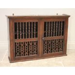 An 18th century Welsh oak wall mounted food cupboard, the pair of doors with bobbin turned