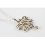 An Edwardian peridot and seed pearl 9ct gold pendant, comprising a central round mixed cut peridot