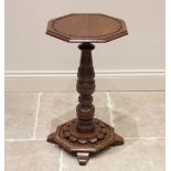 A late 19th/early 20th century Arts and Crafts oak pedestal table in the manner of Bridgens, the