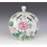 A Chinese celadon glazed jar and cover, 20th century, decorated in famille rose enamels with magpies