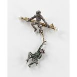 An early 20th century monkey brooch, the unmarked gold coloured bar brooch with cultured pearl