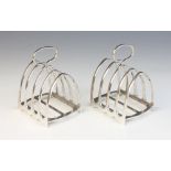 A pair of silver four division toast racks, Garrard & Co, 1957, comprising five arched bars with