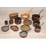 A collection of copper pans, 19th century and later, to include an example with a tapering tubular