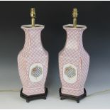 A pair of Chinese export armorial lamp bases, 20th century, each of faceted baluster with pink