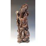 A large Chinese carved figure, early 20th century, modelled as a sage holding a gourd and a staff