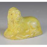 A yellow glazed Staffordshire pearlware lion, circa 1800, modelled recumbent, 6cm high x 8cm wide