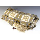 A Welsh blanket by Derw, of traditional reversible design in olive green, cream and black, tasselled